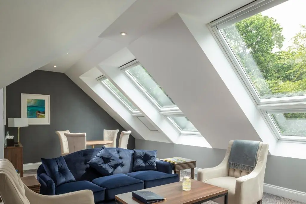 a living room with a blue couch and chairs at Ness Walk in Inverness
