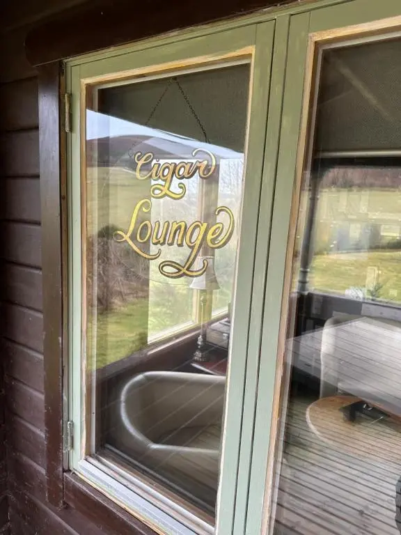 a window with a sign that readserror is lounge at The Gables Whisky B&B in Dufftown
