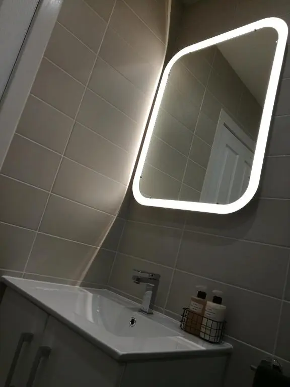 a bathroom with a sink with a light above it at The Hedgehogs in Inverness