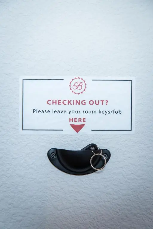 a sign that reads checking out please leave your room keys here at Bazpackers in Inverness