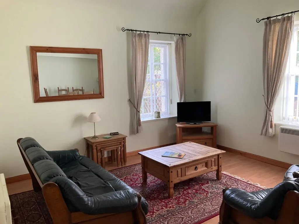 a living room with a couch and a coffee table at Courtyard Cottage Free Parking in Inverness