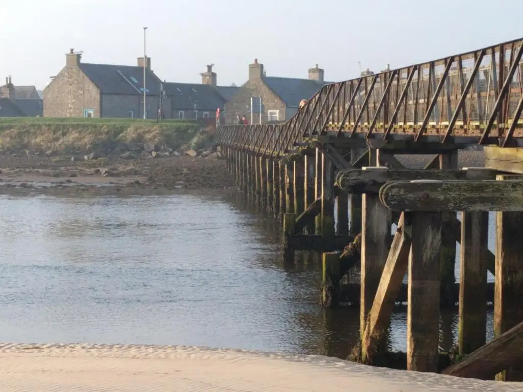 a wooden bridge over a body of water at 6 Seatown, Lossiemouth in Lossiemouth