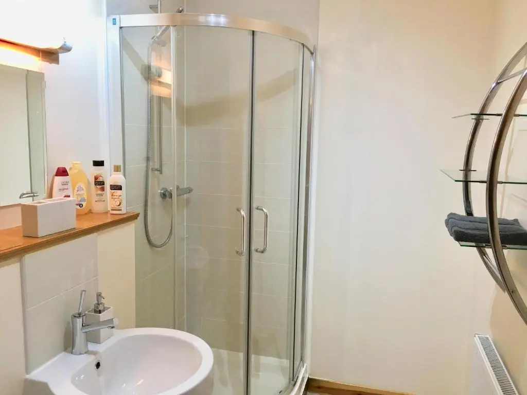 a bathroom with a shower and a sink at Azim and Suzi\u2019s city centre apartment Inverness in Inverness