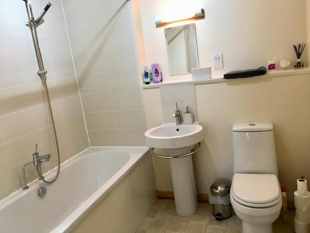 a bathroom with a sink and a toilet and a bath tub at Azim and Suzi\u2019s city centre apartment Inverness in Inverness
