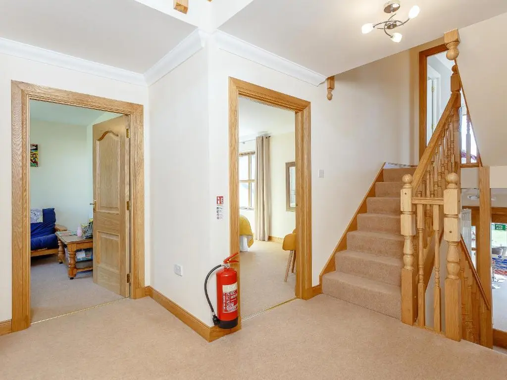 a room with a staircase with a fire extinguisher at The Lookout in Aviemore
