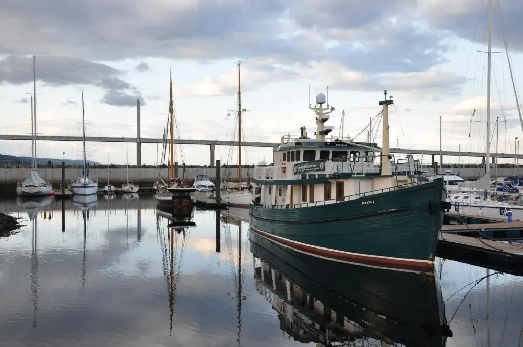 a boat is docked in a harbor with boats at The Boat and Breakfast in Inverness