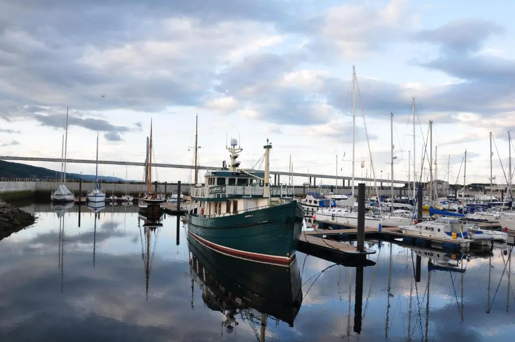 a boat docked in a marina with other boats at The Boat and Breakfast in Inverness