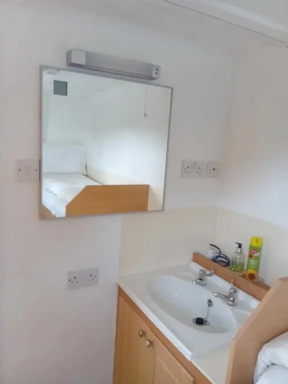 a bathroom with a sink and a mirror at The Boat and Breakfast in Inverness
