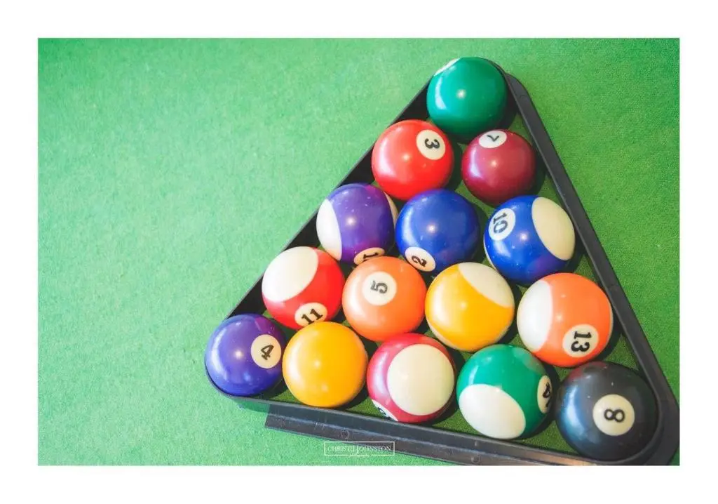 a group of billiard balls in a pool table at Craig Alvah Lodge in Banff