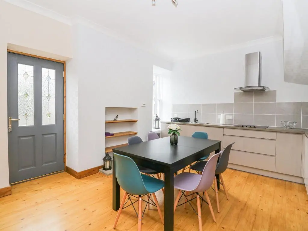 a dining room with a black table and chairs at Westwood in Ballater