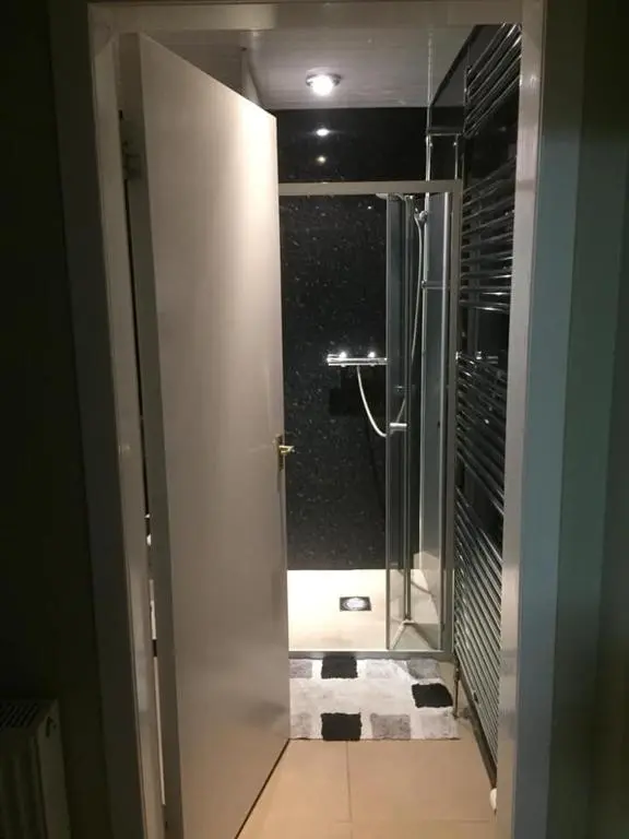 a bathroom with a shower with a glass door at The Cottage Aberlour in Aberlour