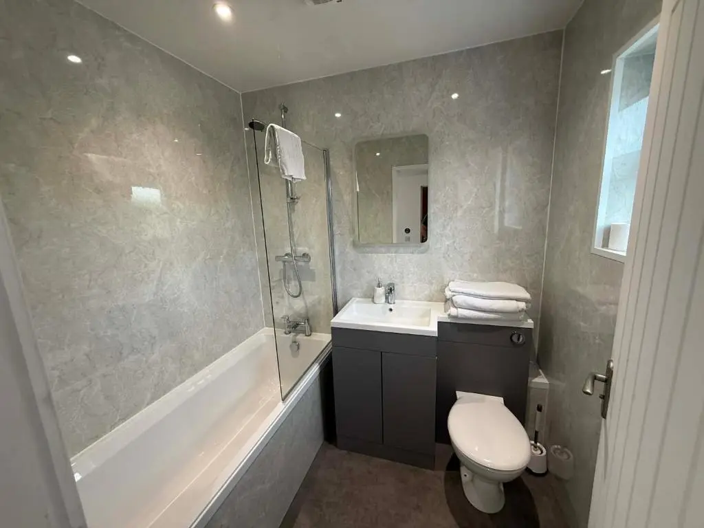 a bathroom with a toilet and a sink and a shower at The Carisbrooke in Forres