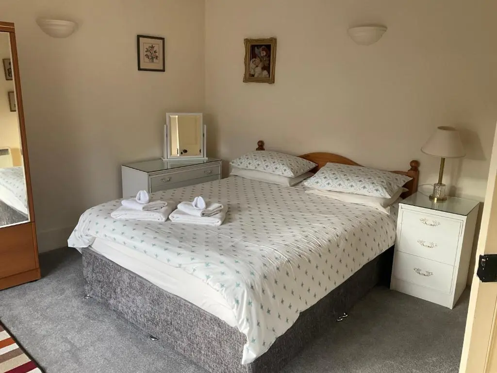 a bedroom with two beds with towels on the bed at Three-Bedroom Old Cottage Free Parking in Inverness