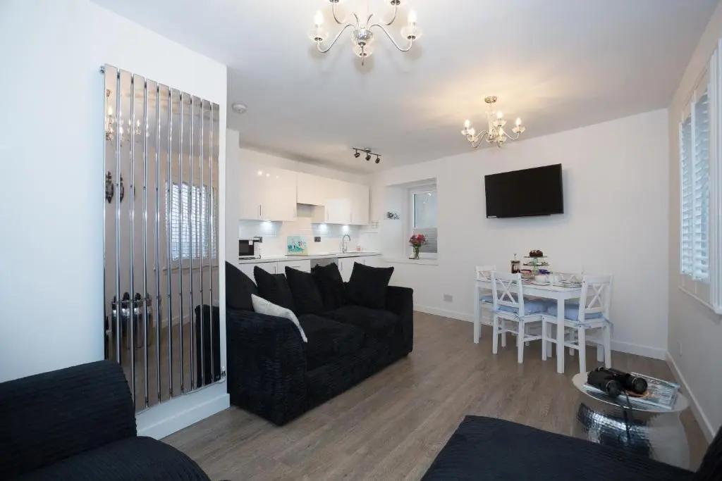 a living room with a couch and a table at Seaesta Apartments in Macduff