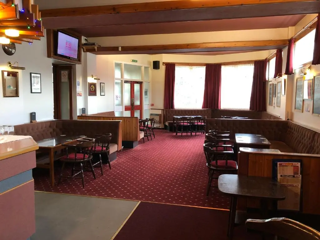 a dining room with tables and chairs in a restaurant at Westerlea Hotel Nairn in Nairn