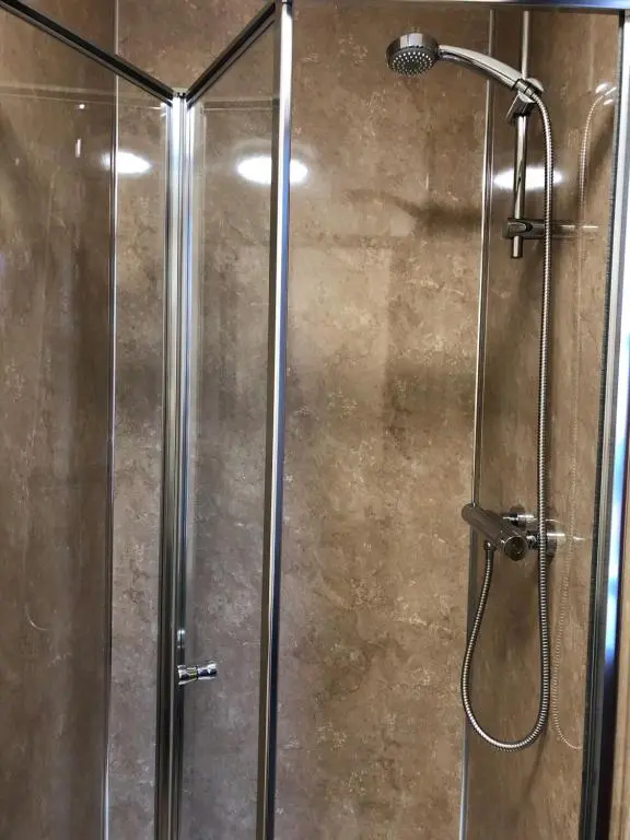 a shower with a glass door in a bathroom at Westerlea Hotel Nairn in Nairn
