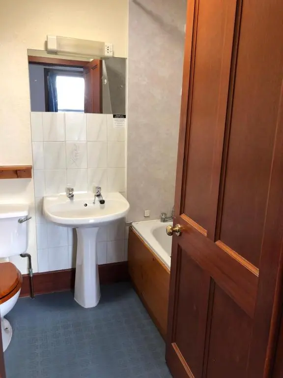 a bathroom with a sink and a toilet and a tub at Westerlea Hotel Nairn in Nairn