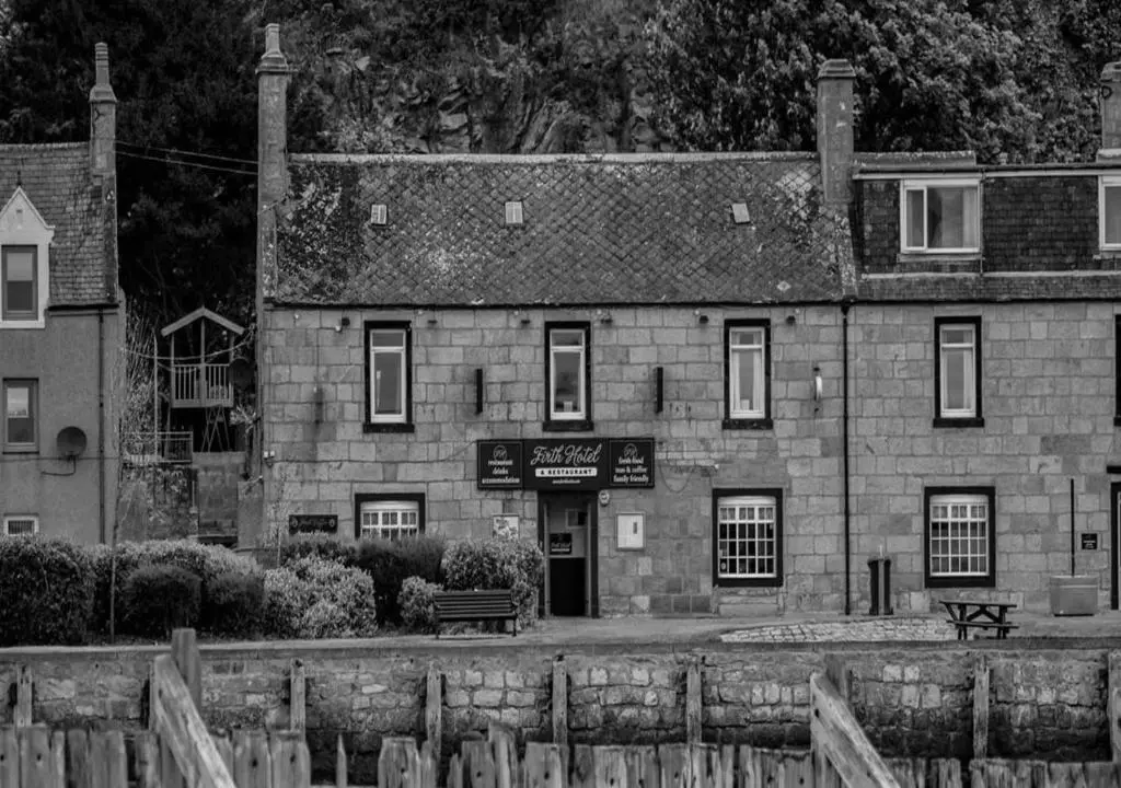 a black and white photo of a stone building at Firth Hotel & Restaurant in Lossiemouth