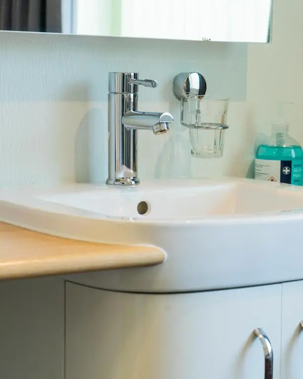 a bathroom sink with a chrome faucet at Firth Hotel & Restaurant in Lossiemouth