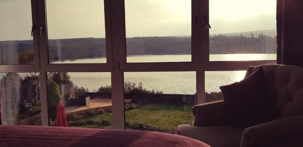 a room with a view of a lake through a window at Airanloch Bed & Breakfast,Loch Ness, Adult Only in Lochend
