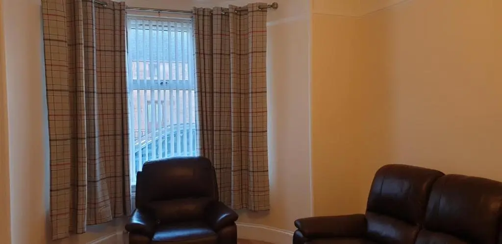 a living room with two chairs and a window at SPRINGBANK Holiday Home in Inverness
