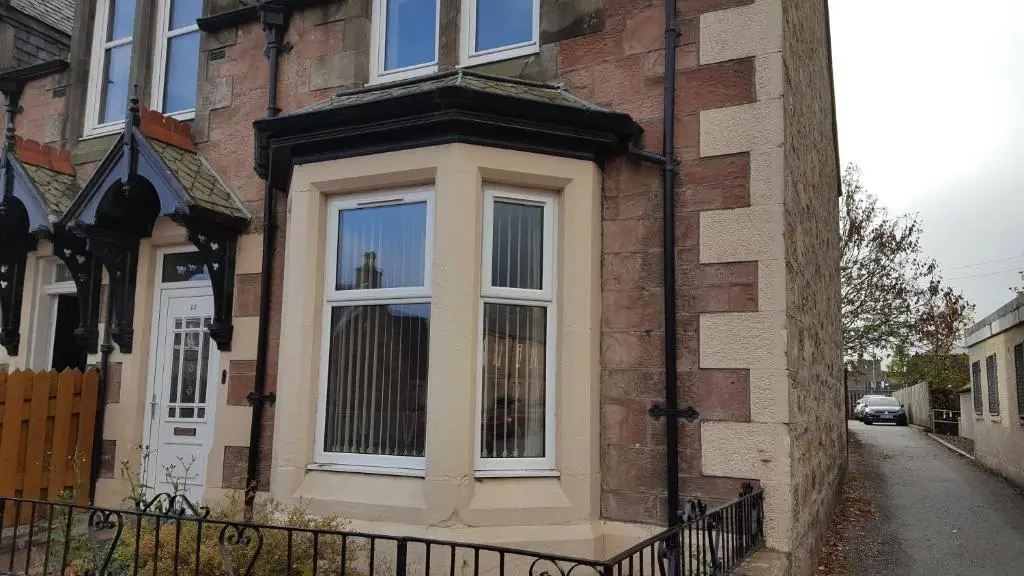 a window on the side of a brick building at SPRINGBANK Holiday Home in Inverness