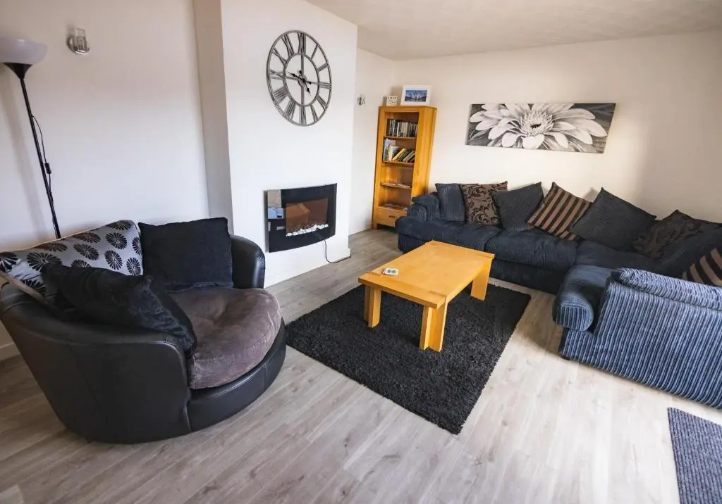 a living room with two couches and a coffee table at Loch Ness Cottage in Fort Augustus