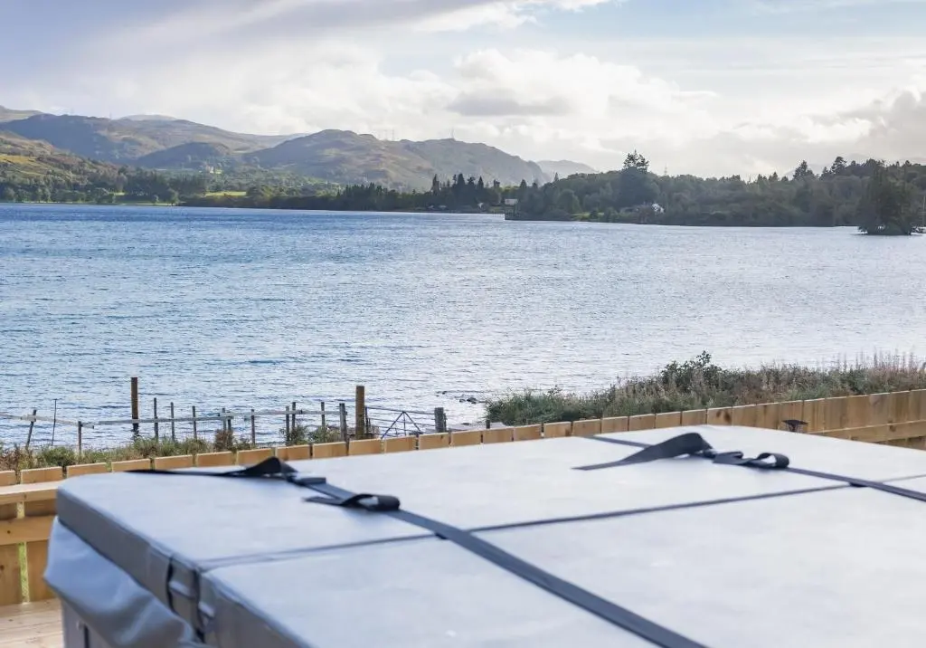 a table in front of a body of water at Loch Ness Cottage in Fort Augustus