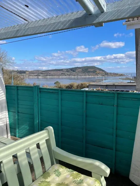 a balcony with a bench and a view of the water at No.9 in Inverness