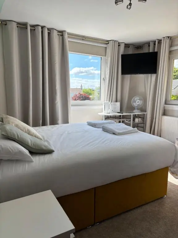 a bedroom with a large bed and a window at No.9 in Inverness