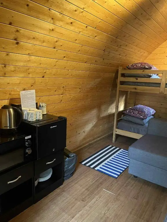 a room with two bunk beds in a cabin at Pine Marten Bar Glenmore Pods in Aviemore