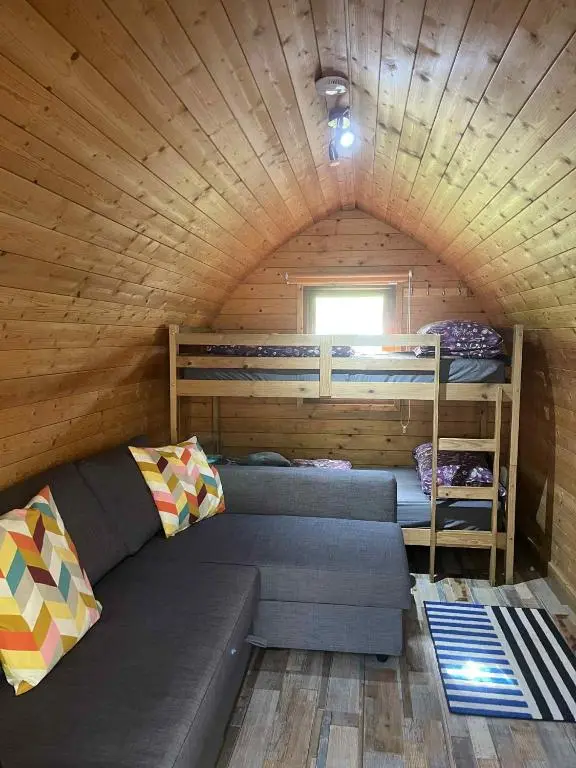 a room with three bunk beds in a cabin at Pine Marten Bar Glenmore Pods in Aviemore