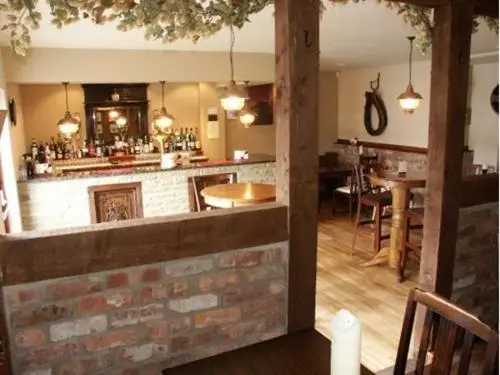 a kitchen with a bar and a dining room at The Commercial Hotel in Tarland