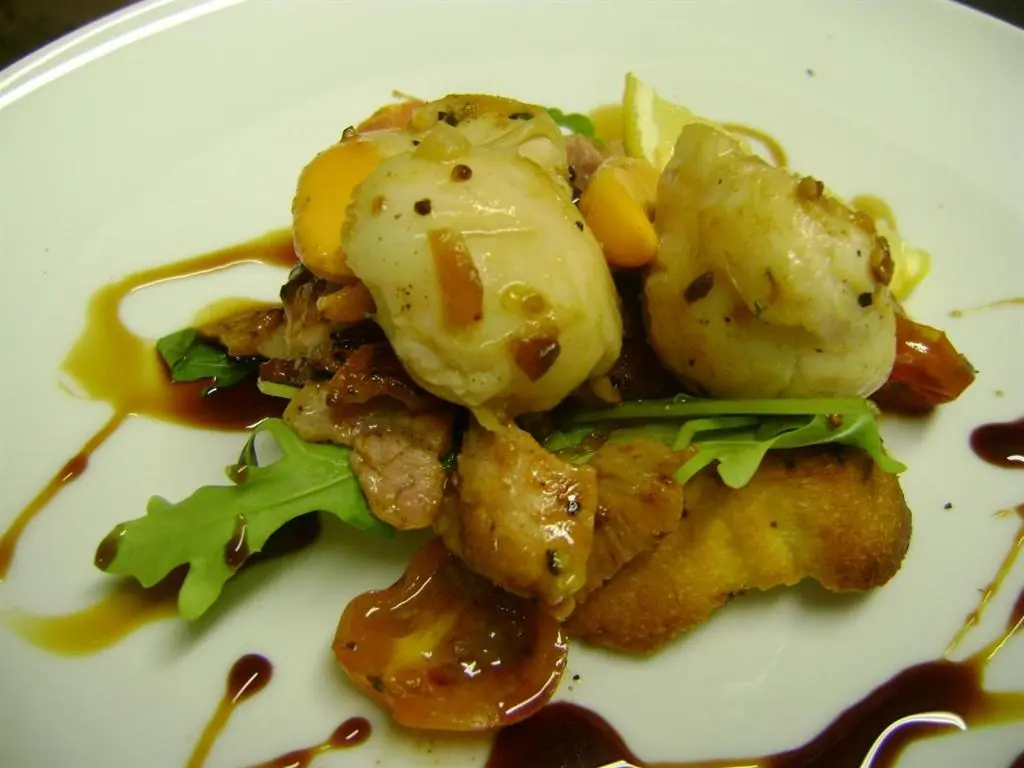 a white plate of food with potatoes and gravy at The Commercial Hotel in Tarland
