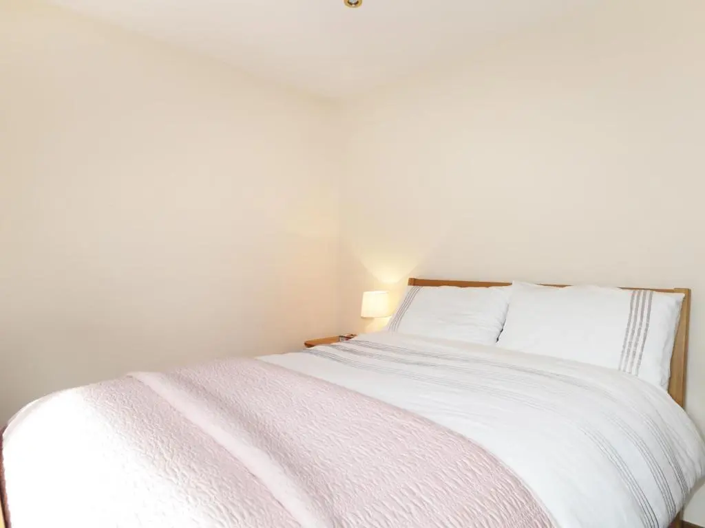 a white bed with white sheets and pillows at St Aethans in Inveran