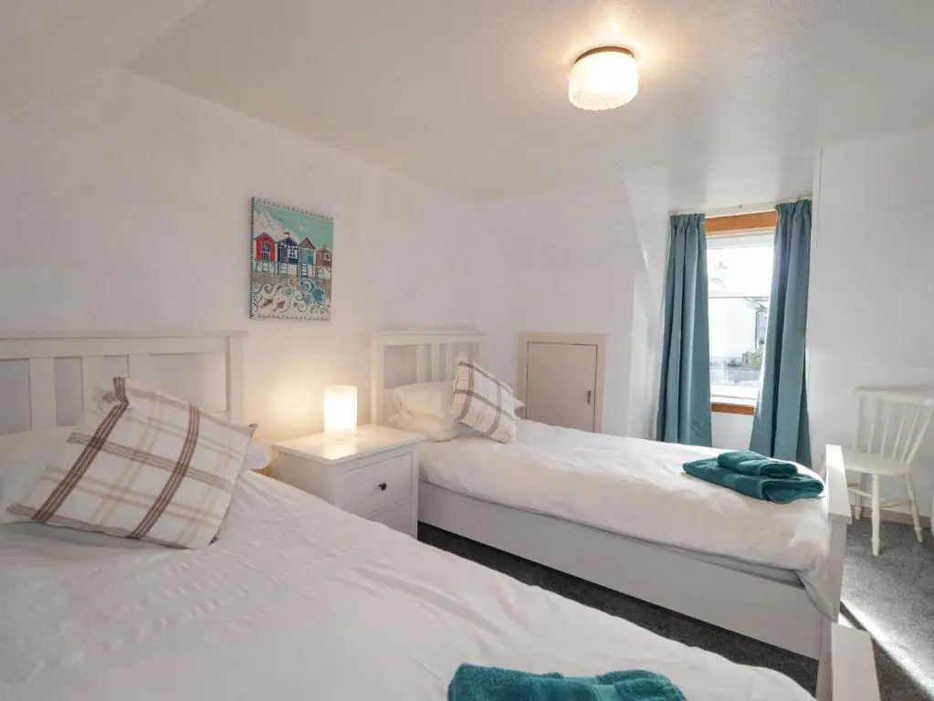 a bedroom with two beds and a window at 19 Reidhaven Street in Banff