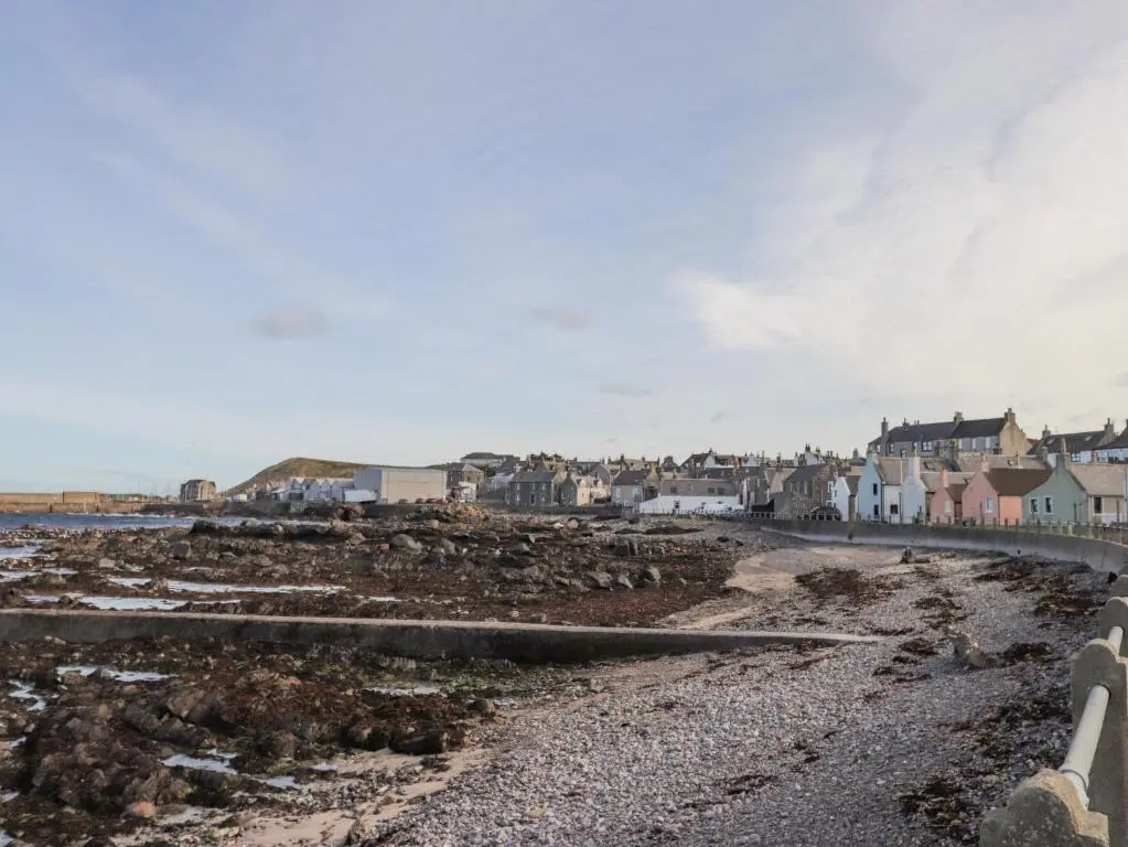 a beach with houses and a town in the background at 19 Reidhaven Street in Banff