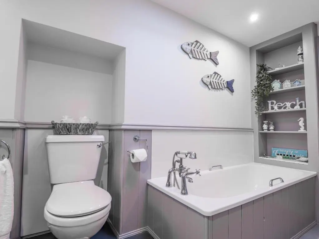 a bathroom with a toilet and a bath tub at 83 Seatown in Buckie