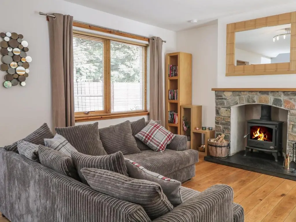 a living room with two couches and a fireplace at Dolce Casa in Grantown on Spey