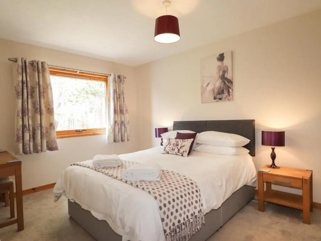 a bedroom with a bed and a window at Millview in Boat of Garten
