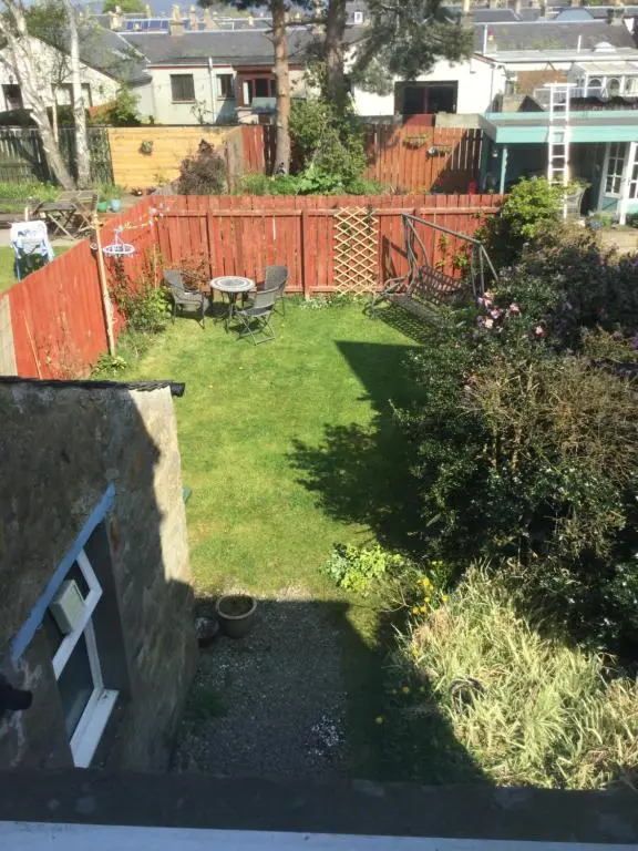 a backyard with a garden with a fence at 63 Argyle Street in Inverness