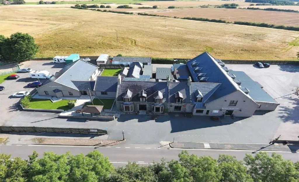 an aerial view of a large house with a yard at Ban Car Hotel in Cairness