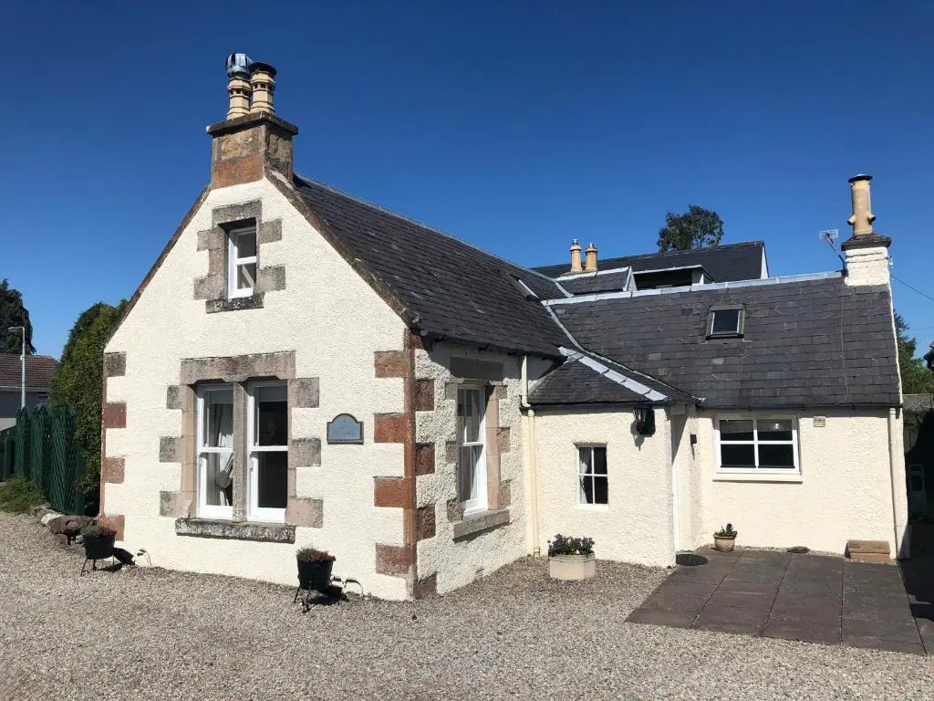 a small white building with a black roof at New Cottage 3 Bedroom Free Parking in Inverness
