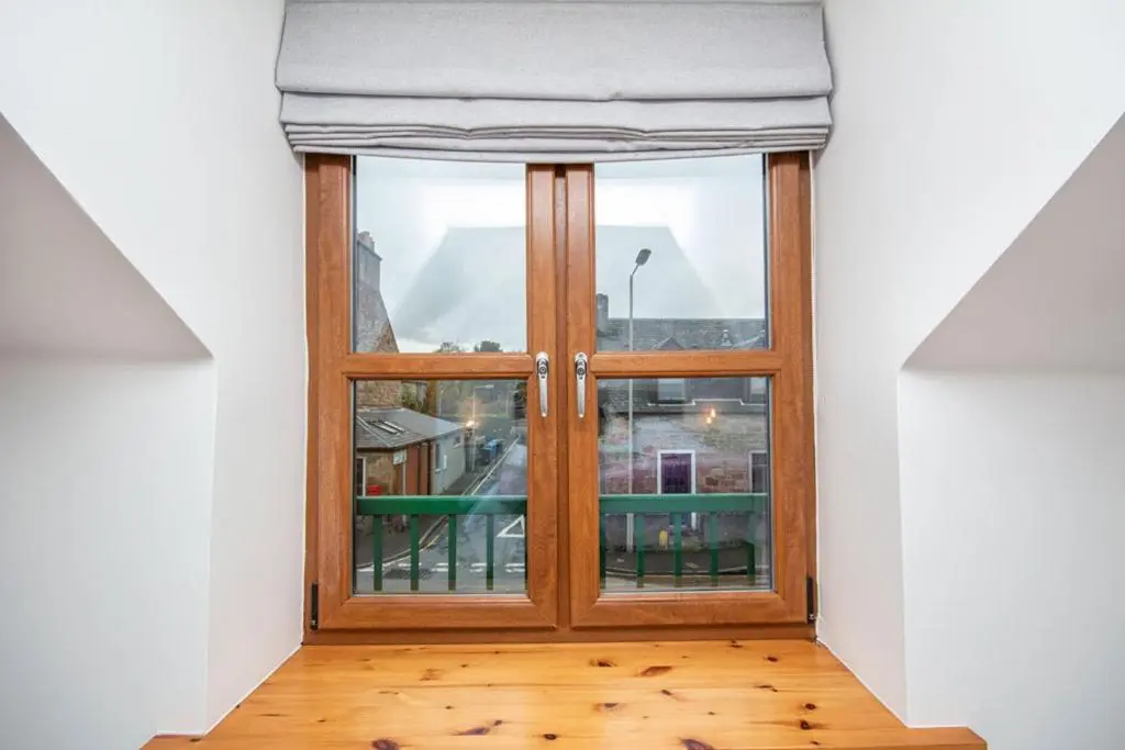 a room with a glass door with a window at Innes Street Apartments in Inverness