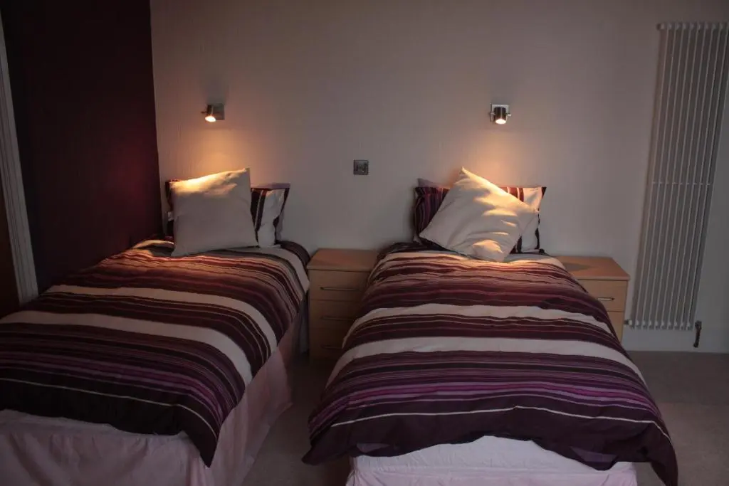 two beds sitting next to each other in a room at Harbour House Bed & Breakfast - Wick in Wick