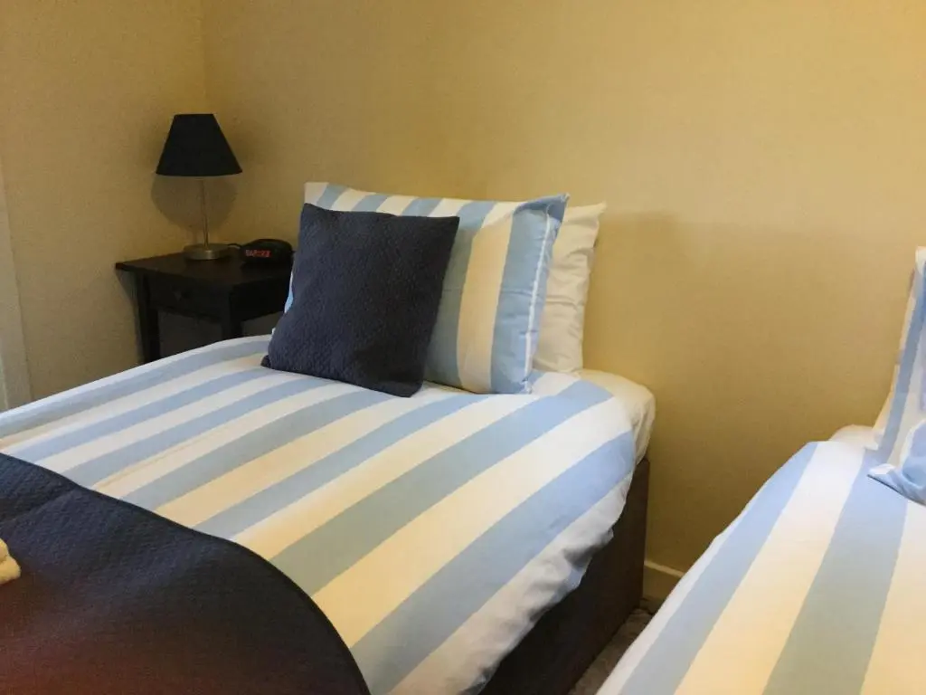 a bedroom with two beds with blue and white stripes at Darroch View B&B in Invermoriston