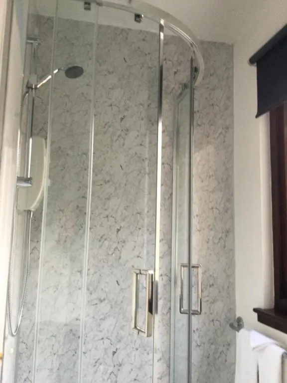 a shower with a glass door in a bathroom at Darroch View B&B in Invermoriston
