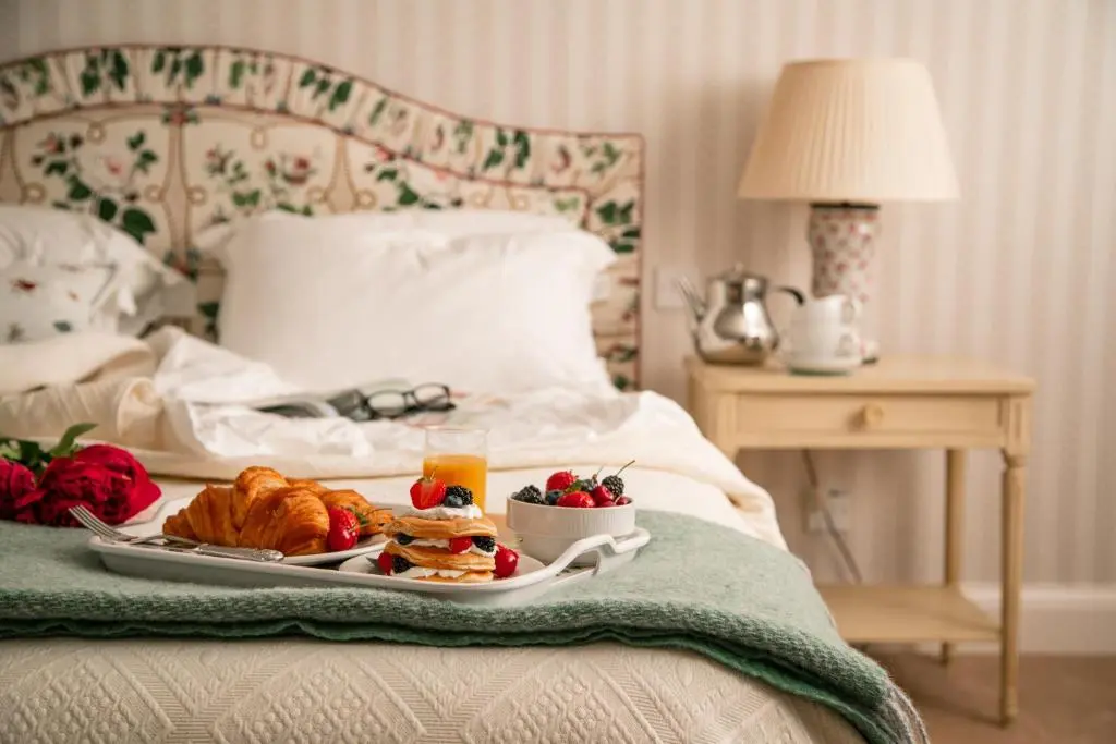 a tray of breakfast food on a bed at Balnagown Estates in Kildary