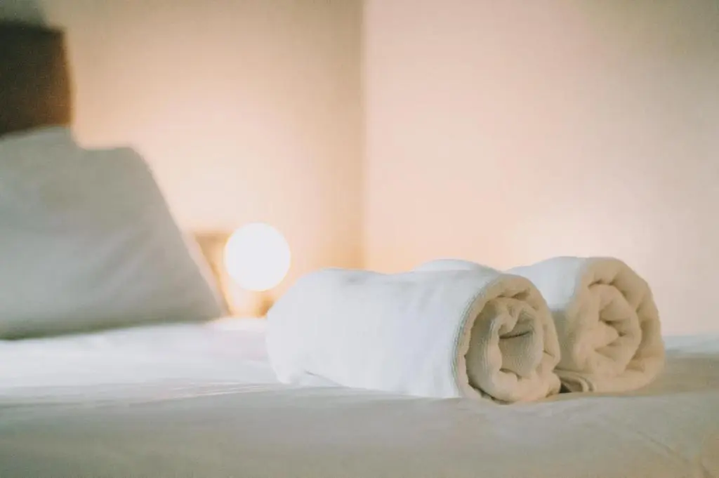 a pile of towels sitting on top of a bed at The Black Isle Retreat in Inverness