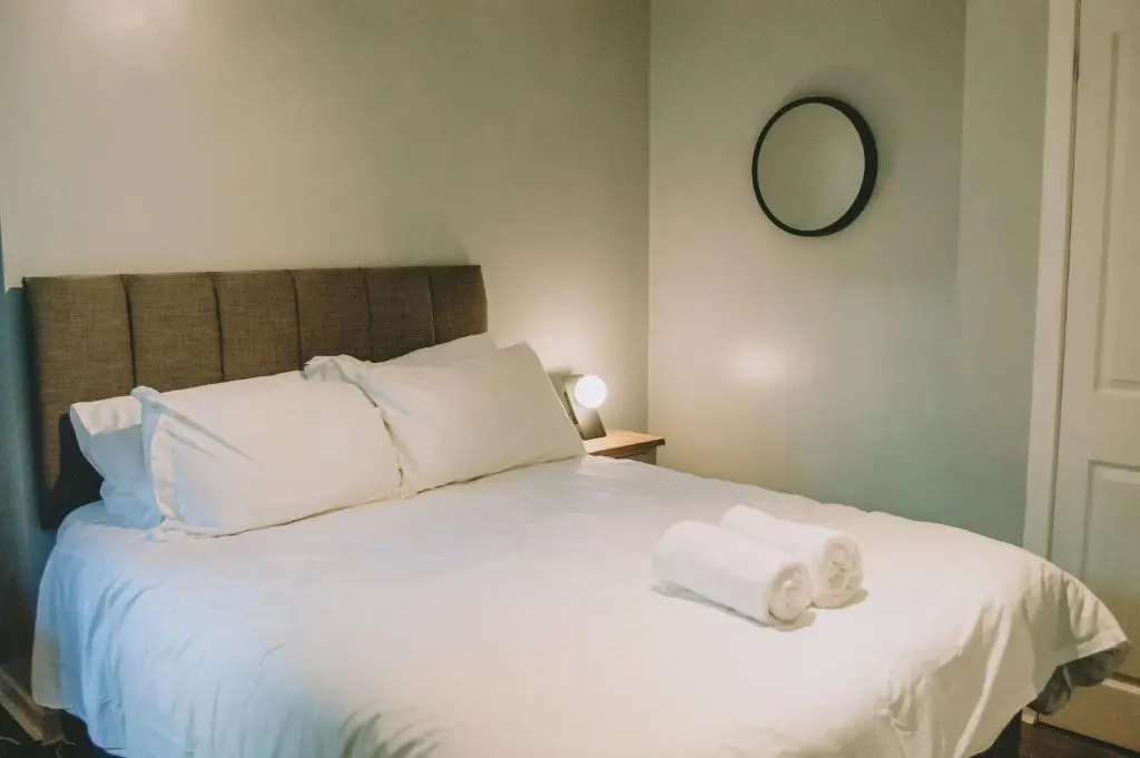 a bedroom with a bed with two towels on it at The Black Isle Retreat in Inverness